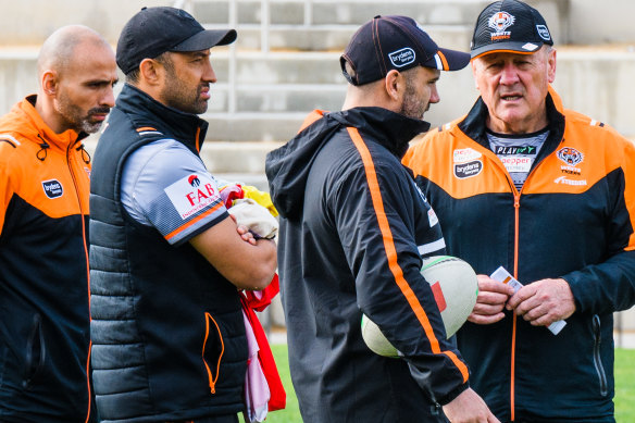 Assistant coach Benji Marshall (second from left) and head coach Tim Sheens (right).