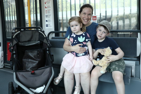 Paula Moylan with her children, Hugh and Audrey, on the light rail on Saturday.