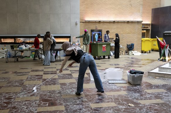 Students pack up their camp inside the Arts West building after the university agreed to disclose its ties to weapons manufacturers.