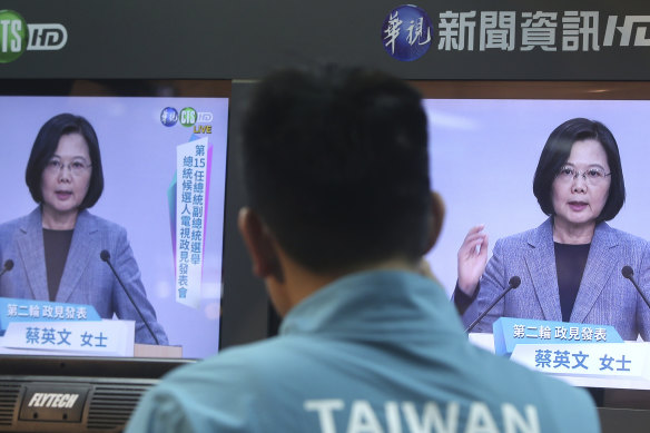 A Taiwanese man watches the Democratic Progressive Party leader Tsai Ing-wen speak during a policy address.