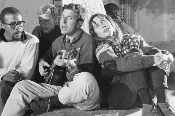 Leonard Cohen playing his guitar in  Greece with Charmian Clift, pictured in 1960.