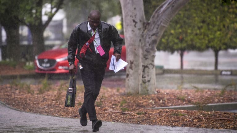 Heads down: A punter arrives at Flemington.