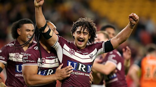 Manly centre Morgan Harper  celebrates scoring a try against Wests Tigers.