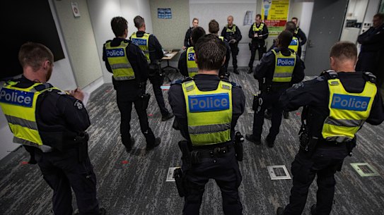 Members of Victoria Police Public Order Response Team take part in a pre-shift briefing.