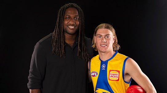 Harley Reid of the Eagles poses for a photograph with retired Eagles star Nic Naitanui.