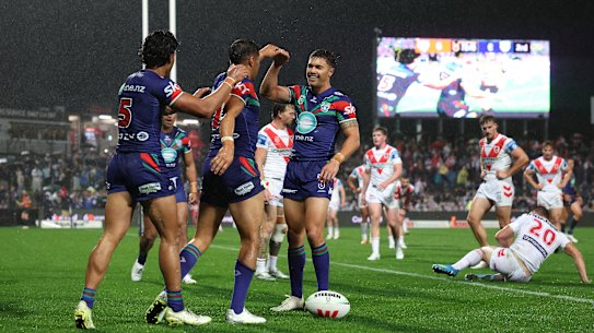 The Warriors celebrate a Te Maire Martin try against the Dragons on Saturday.