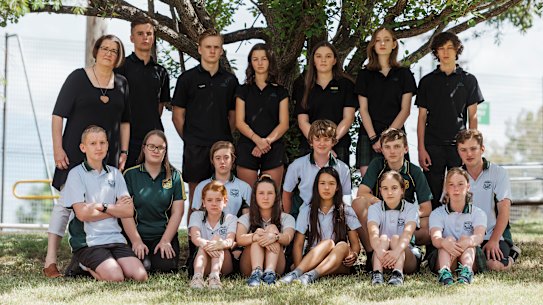 Students from Springwood High cool off in the shade after a hot day in their unairconditioned school