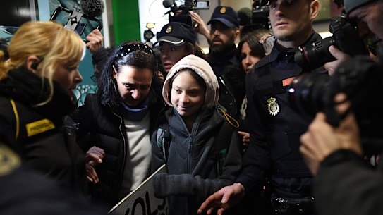 Thunberg was surrounded by supporters and police after arriving in Spain by train from Lisbon.