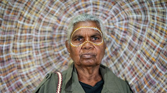 Sydney Morning Herald and The Age: Artist Regina Pilawuk Wilson’s poses for a portrait in front of her painting Wupun (sun mat) at the Michael Reid Gallery in Washington, DC.  Regina Pilawuk Wilson is carrying a bag she made. photo: Leigh Vogel  15 October 2025 