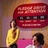 American artist Laura Allcorn (yellow top) with her work Pledge Drive For Attention.