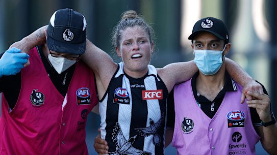 Brianna Davey leaves the field injured during round one. 
