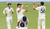 Mitchell Starc and Cameron Green celebrate the wicket of India captain Ajinkya Rahane on Sunday. 