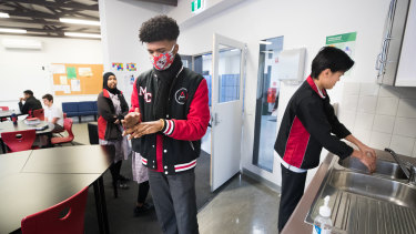 Year 12 students at Mount Alexander College wash and sterilise their hands before class on Tuesday morning. 