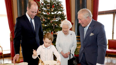 Prince William, Prince George, the Queen and Prince Charles prepare special Christmas puddings in the Music Room at Buckingham Palace.