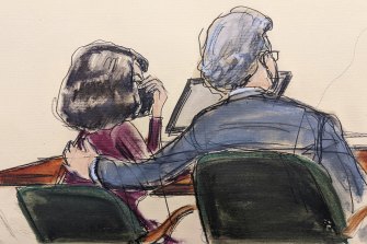 Ghislaine Maxwell, with her lawyer Jeffrey Pagliuca, puts her hand to her face as she listens to the guilty verdict being read out.