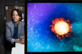 Scientist Deborah Williamson at the Doherty Institute with an electron microscope image of the SARS-CoV-2 omicron variant of the coronavirus.  