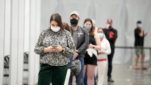 People line up at the newly-opened vaccination hub at the Brisbane Convention & Exhibition Centre. 
