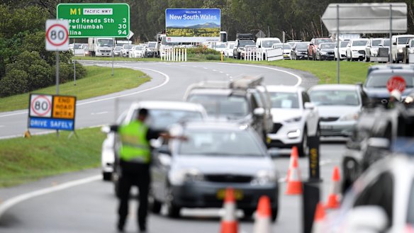 Vehicles queued up at a police checkpoint at the Queensland/NSW border in Coolangatta on Monday.