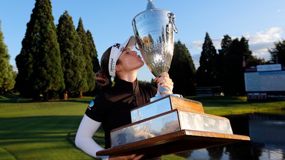 Hannah Green poses with the oversized trophy after winning the Portland Classic.