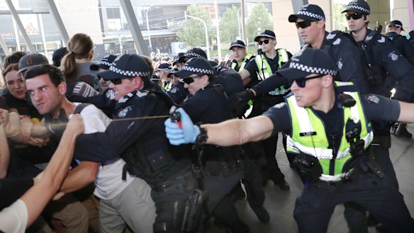 Police use pepper spray as protesters attempt to stop conference members entering the mining conference in October. 