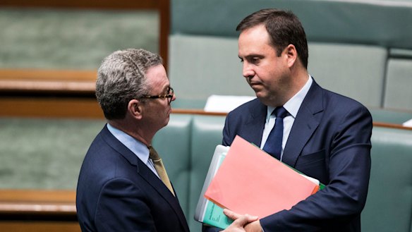 Christopher Pyne (left) speaks to Steve Ciobo in the House of Representatives. 