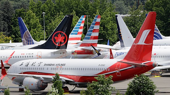 Dozens of grounded Boeing 737 MAX planes crowd a parking area near its factory in Seattle.