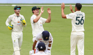 Mitchell Starc and Cameron Green celebrate the wicket of India captain Ajinkya Rahane on Sunday. 