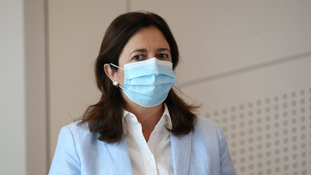 Premier Annastacia Palaszczuk wearing a mask at a press conference.