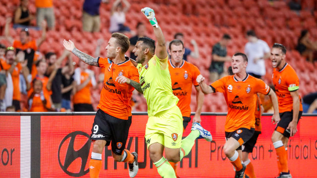 Roaring back: Adam Taggart leads a joyous Brisbane celebration after his last-play equaliser.