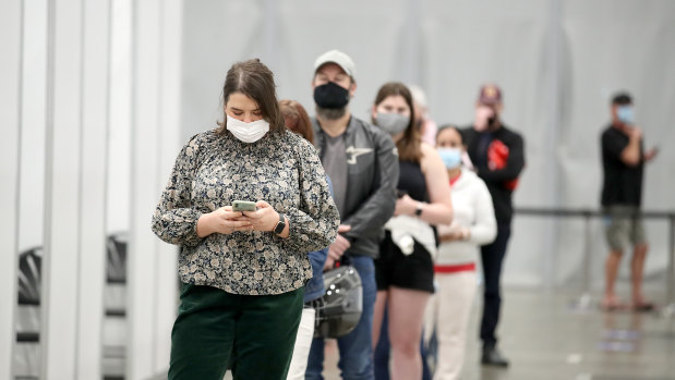 People line up at the newly-opened vaccination hub at the Brisbane Convention & Exhibition Centre. 