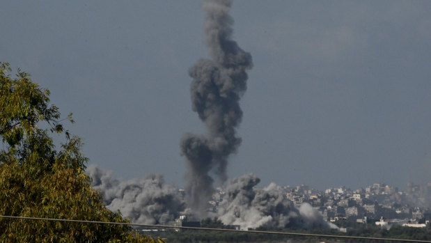 Smoke rises from buildings, viewed from the Israeli side of the border, as the Israeli military conducts a bombardment in northern Gaza.