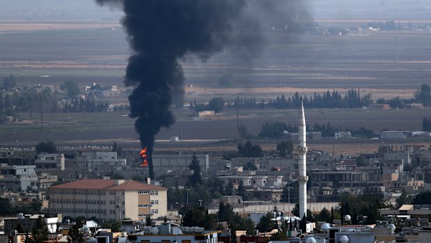 Smoke billows from a fire in Ras al-Ayn, Syria. 