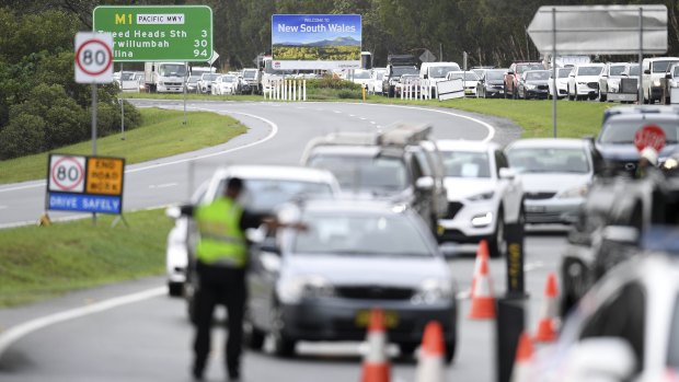 Vehicles queued up at a police checkpoint at the Queensland/NSW border in Coolangatta on Monday.