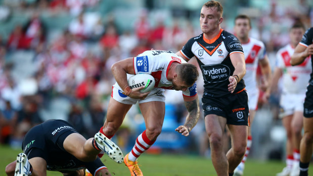 The Dragons’ Tariq Sims runs into the Tigers defence.