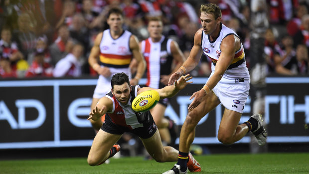 Hope and a prayer: Saints' Paddy McCartin  attempts to spoil Daniel Talia of the Crows.