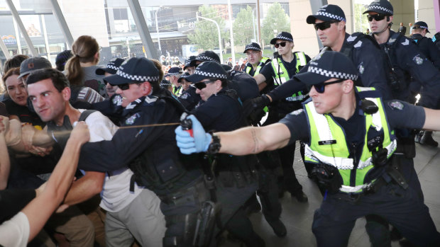 Police use pepper spray as protesters attempt to stop conference members entering the mining conference in October. 