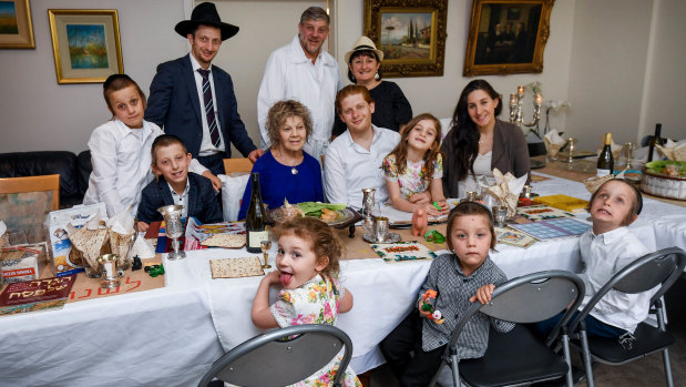 Masha Fisher surrounded by family at the table for Passover as easing health restrictions allow the Jewish gathering to occur in homes.