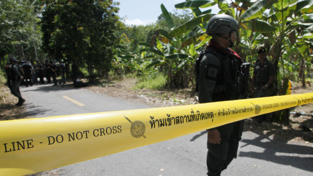 Police secure the road leading to a shooting scene, in Yala province, Thailand, on Wednesday.