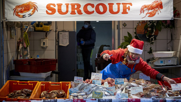 A fishmonger sets up her stall of at Boulogne-sur-Mer, France's largest fishing port, where the bulk of the catch comes from British waters. The EU is looking to maintain extensive access to the waters as part of a Brexit deal.