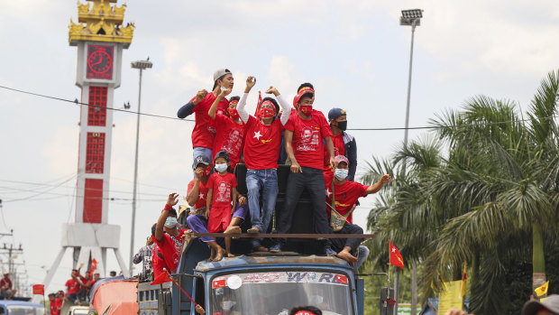 Supporters of Myanmar Leader Aung San Suu Kyi's NLD party cheer from a truck on the final day of campaigning for elections.