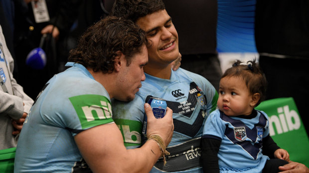 Job well done: Latrell Mitchell, with James Roberts and daughter Inala, lets the series victory sink in after NSW's game two win.