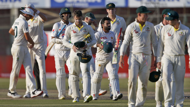 Pakistani and Australian players leave the ground at the end of the second Test. 