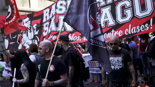 Members of the group RASH–SHARP Santiago ANTIFA (Anti-Fascism Action) attend a march in favour of migrants, organised by the National Immigrants Co-ordinator, in downtown Santiago last month.