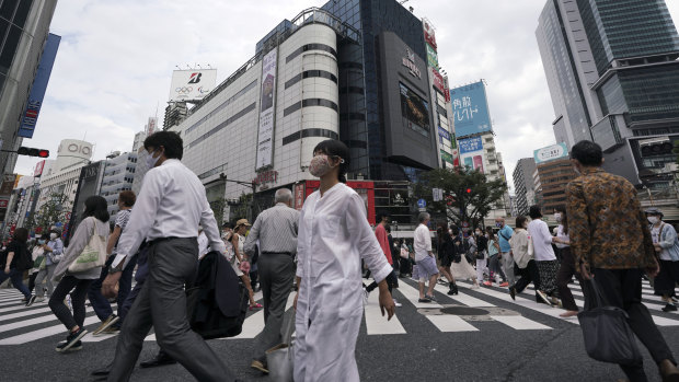 Commuters walk at Shibuya pedestrian crossings in Tokyo on Monday.