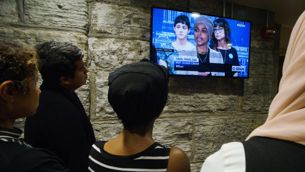 People gather in an overflow room to watch a news conference with representatives Ilhan Omar, a Democrat from Minnesota, and Rashida Tlaib, a Democrat from Michigan, not pictured, in St Paul, Minnesota.