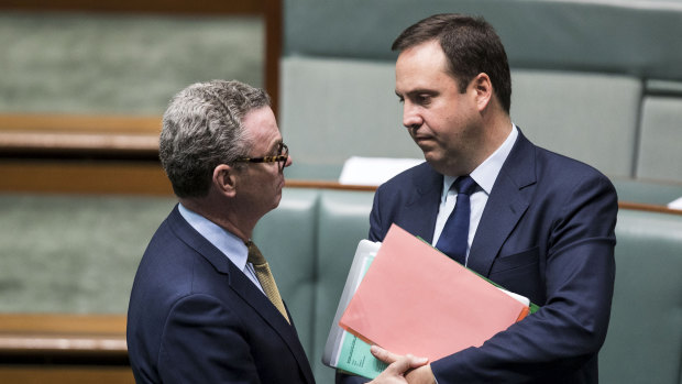 Christopher Pyne (left) speaks to Steve Ciobo in the House of Representatives. 