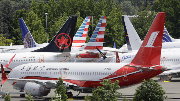 Dozens of grounded Boeing 737 MAX planes crowd a parking area near its factory in Seattle.