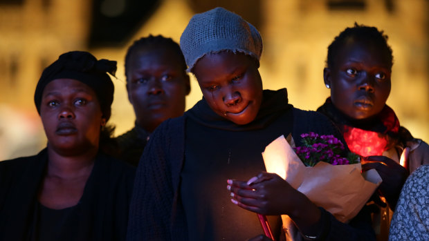 Hundreds of mourners, including Natalina Angok's sister Helena (pictured centre), have attended a vigil at Federation Square.