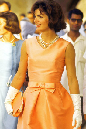 Jackie Kennedy wearing a triple strand of pearls on a visit to India.