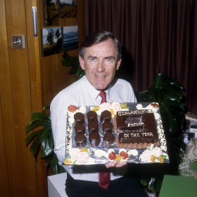 Brian Naylor holding a cake for Father of the Year.